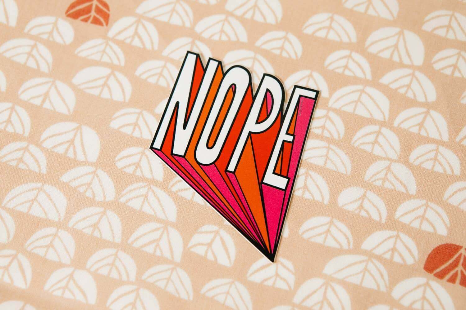 Nope Vinyl Decal Sticker on patterned background for laptops, journals, and water bottles. Fun journal supply and prompt addition.