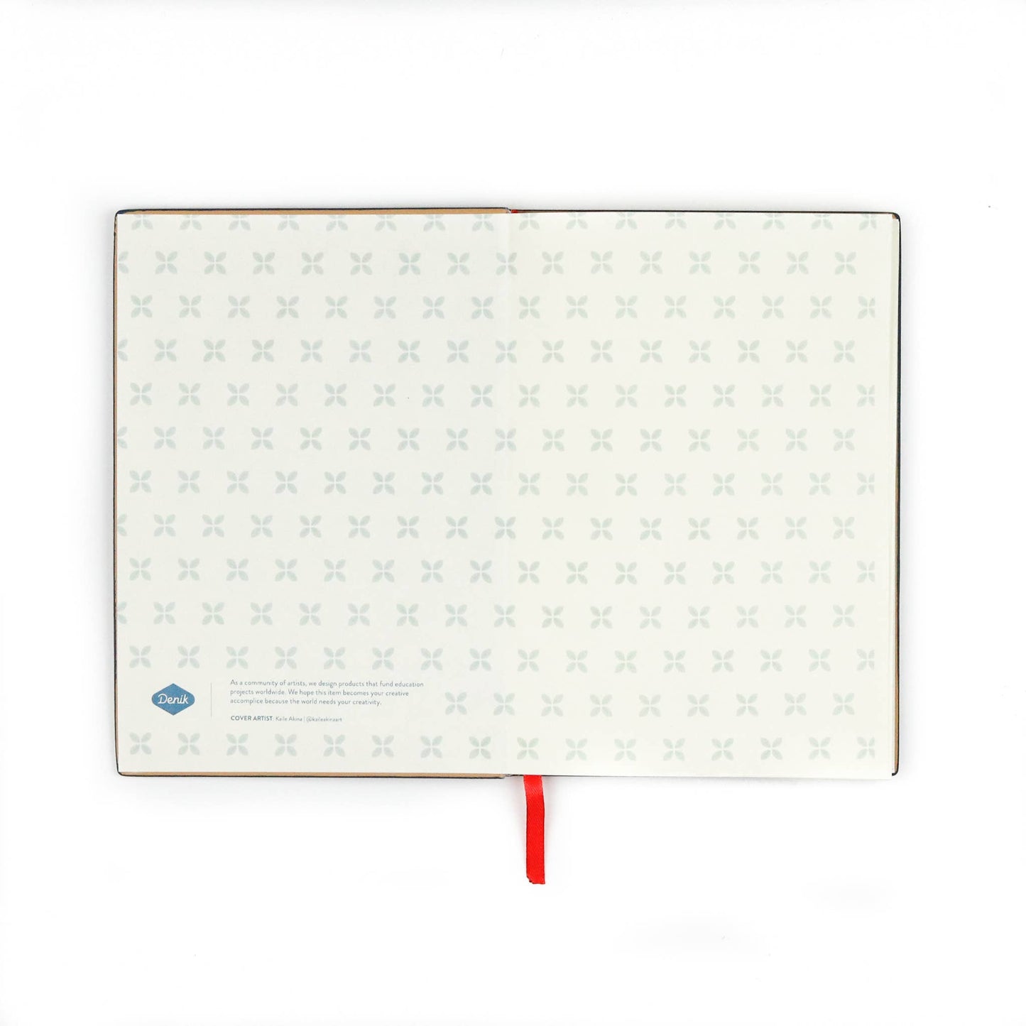 Open Evelynn Embroidered Layflat Journal Notebook displaying cream-colored pages and a red satin ribbon bookmark against a white background.