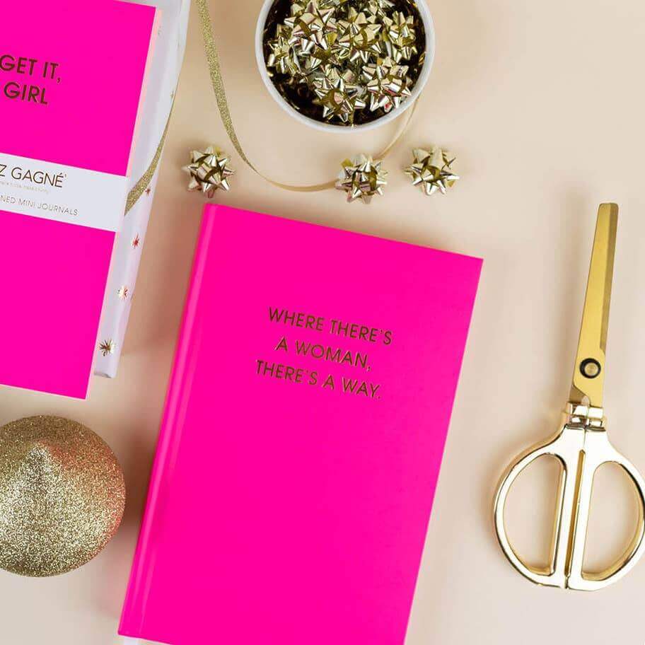 Bright pink "Where There's A Woman There's A Way" journal with gold foil print, perfect for journaling and guided prompts, with journal supplies.