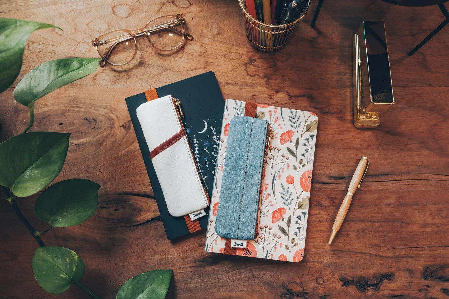 Stylish golden hour embossed vegan leather notebook pouches for journaling essentials, featuring lush faux suede and elastic bands around journals.