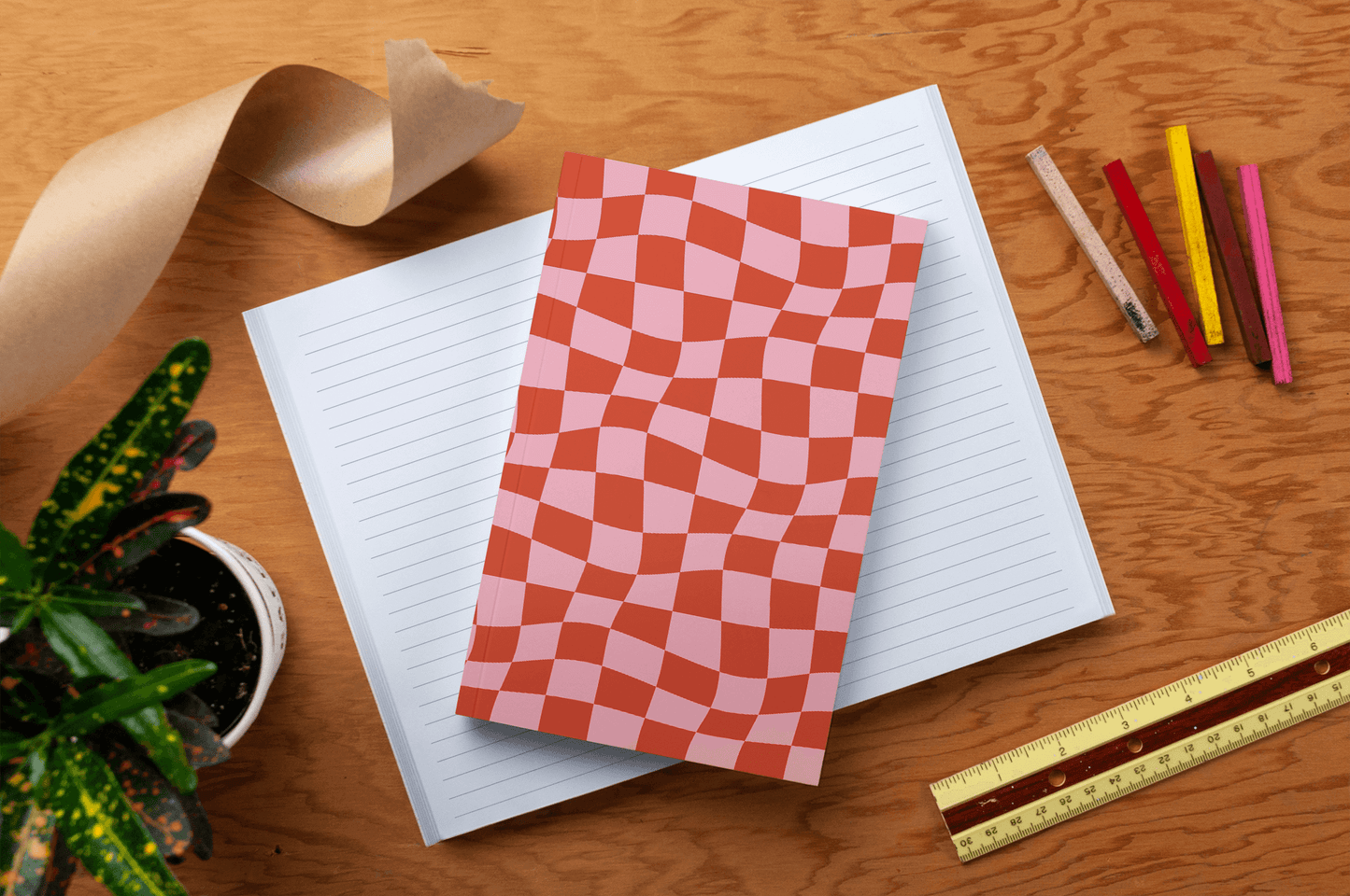 Wonky Checkers Classic Layflat Journal Notebook for guided journaling, featuring a vibrant and durable water-resistant cover on a wooden desk.