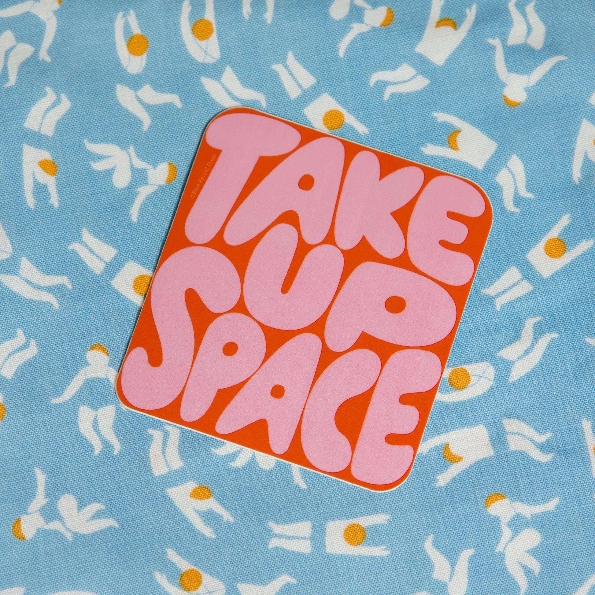 "Take Up Space Vinyl Decal Sticker on a blue patterned background, ideal for journaling and adding personality to your journal supplies"