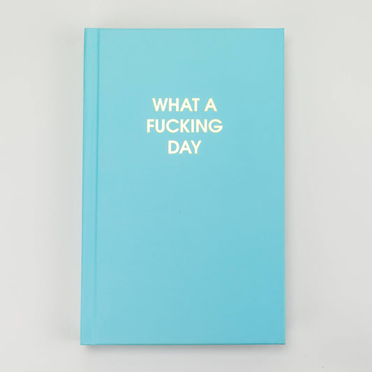 Bright blue journal with gold foil text "What a F'ing Day" - perfect for venting and journaling your thoughts.