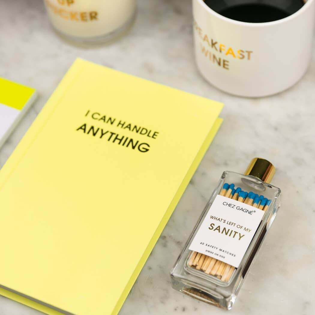 Bright lemon yellow hardcover "I Can Handle Anything" journal with nearby matches and coffee mug - perfect for journaling and guided prompts.