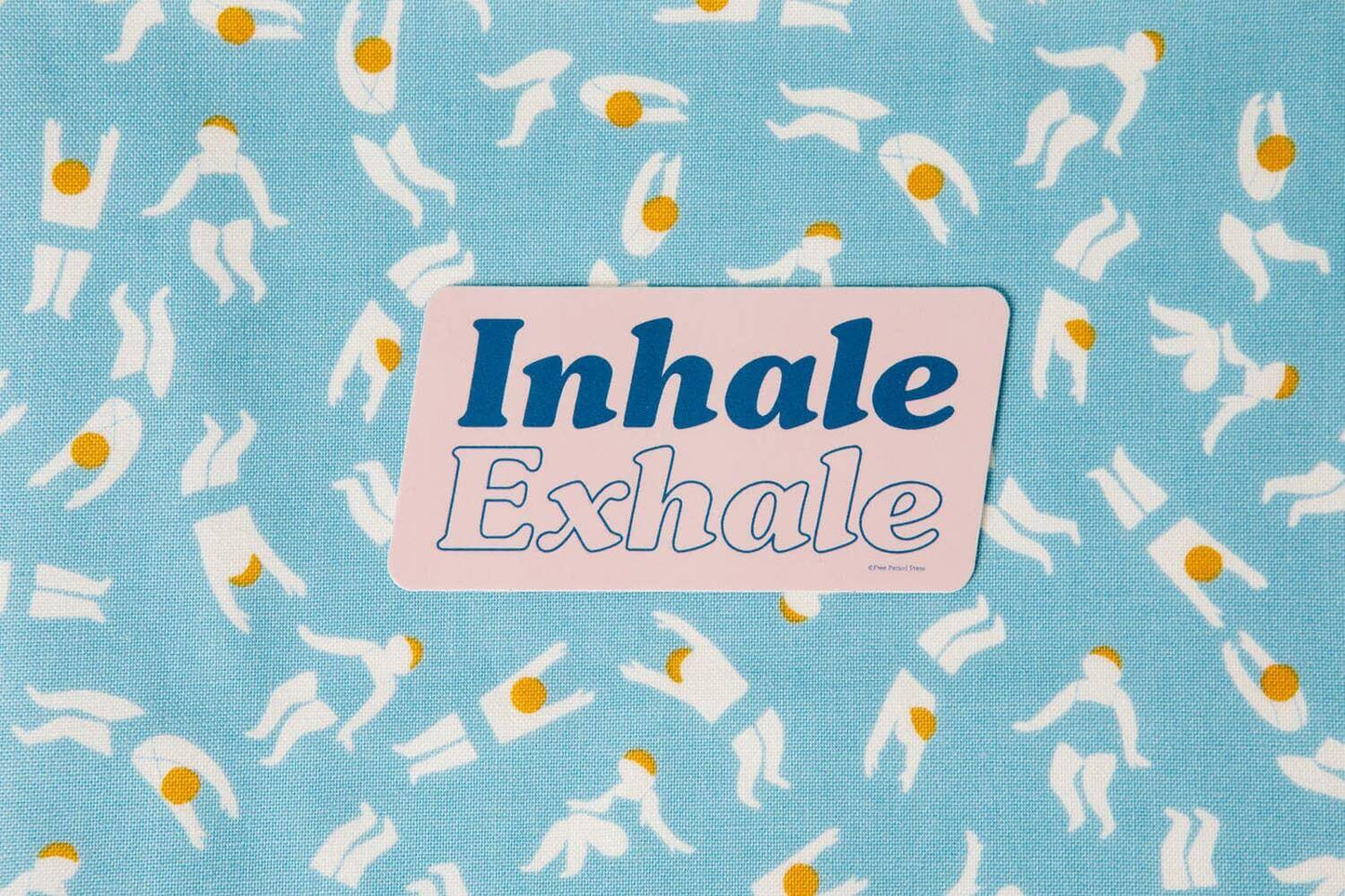 "Inhale Exhale vinyl decal sticker on a blue patterned background, perfect for journaling and journal prompts, designed by Katie Daugherty."