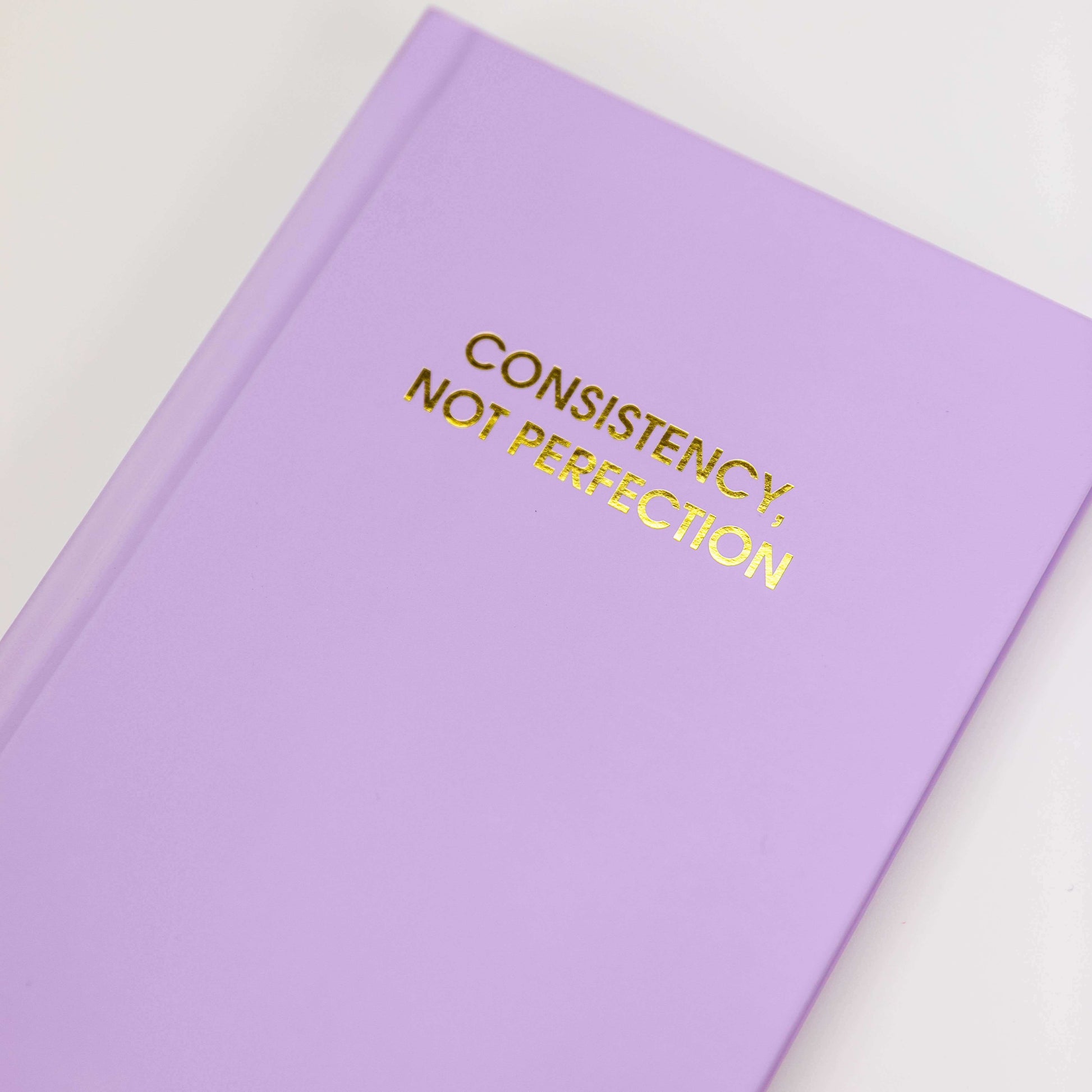 Consistency Not Perfection bright hardcover journal with gold foil printing for journaling, journal prompts, and guided journaling.