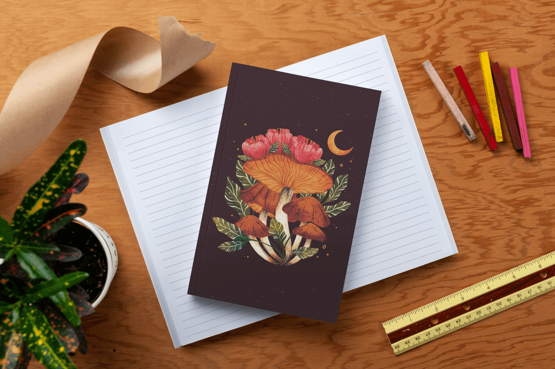 Midnight Mushroom Layflat Journal Notebook on a wooden desk with pencils, ruler, and plant - perfect for journaling and journal prompts