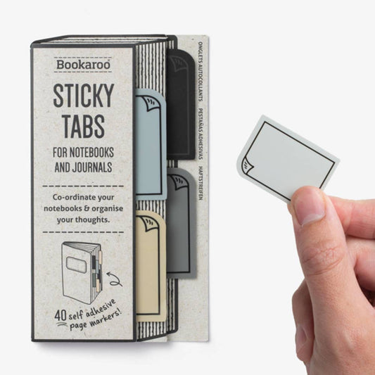 Bookaroo Sticky Tabs for notebooks and journals held in hand, perfect for organizing journaling ideas and guided journal prompts.