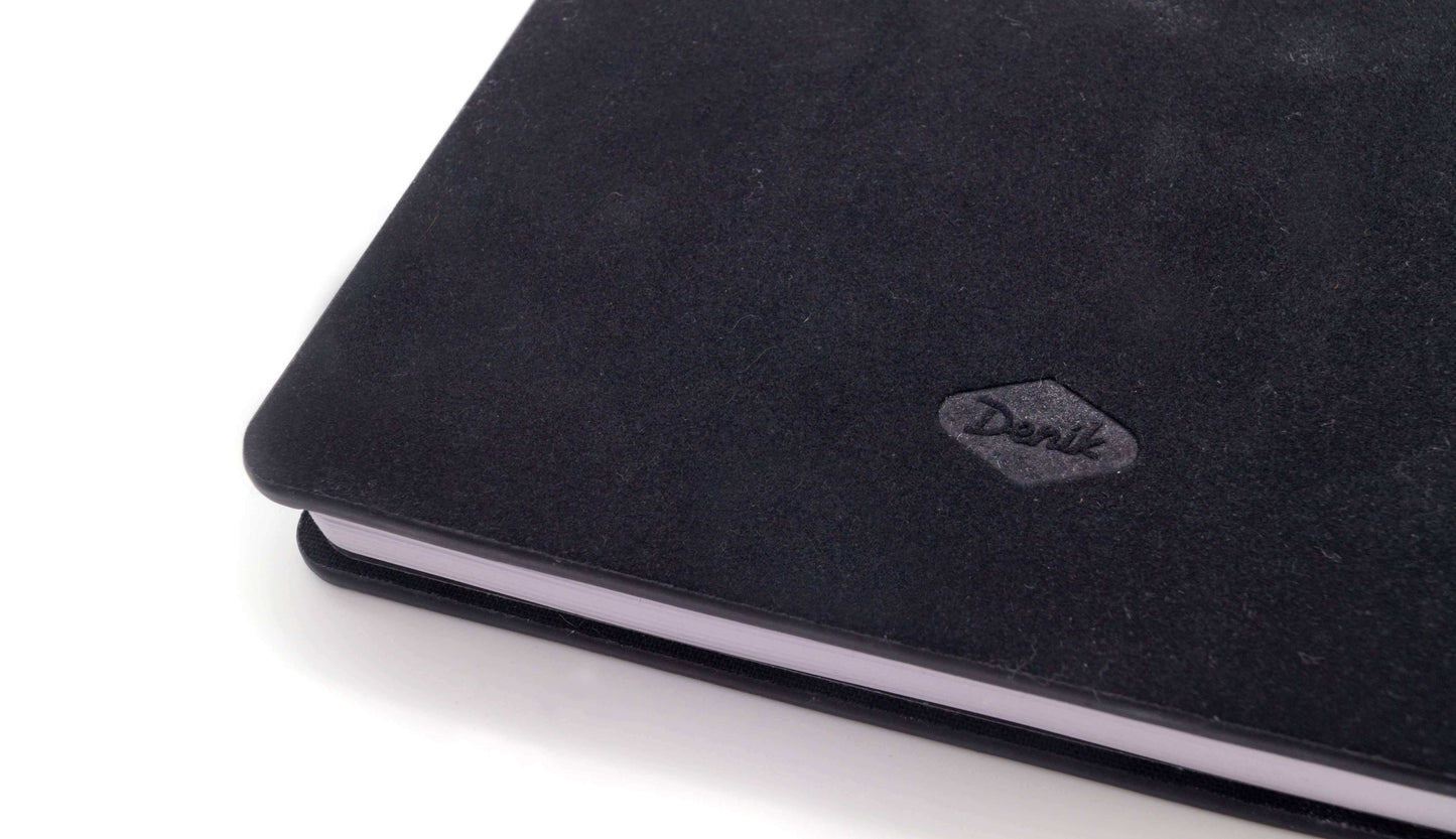 Close-up of Awakening Embroidered Journal Notebook hardcover showing elegant black cover with stitching detail. Perfect for stylish journaling.