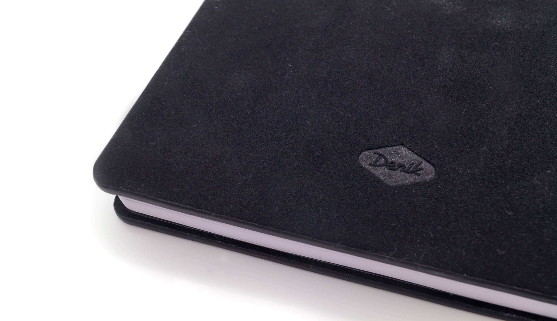 Close-up of Awakening Embroidered Journal Notebook hardcover showing elegant black cover with stitching detail. Perfect for stylish journaling.