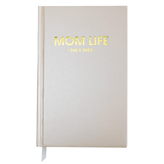 Coral sparkle hardback "Mom Life (She's Tired)" journal with gold foil printing, 256 ruled sheets, and white page tracking ribbon.