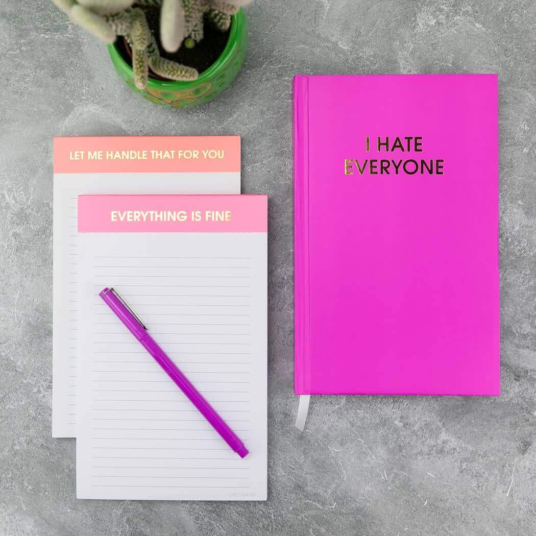 Bright pink 'I Hate Everyone' journal with gold foil and lined pages, perfect for guided journaling and prompts, with handy page markers.