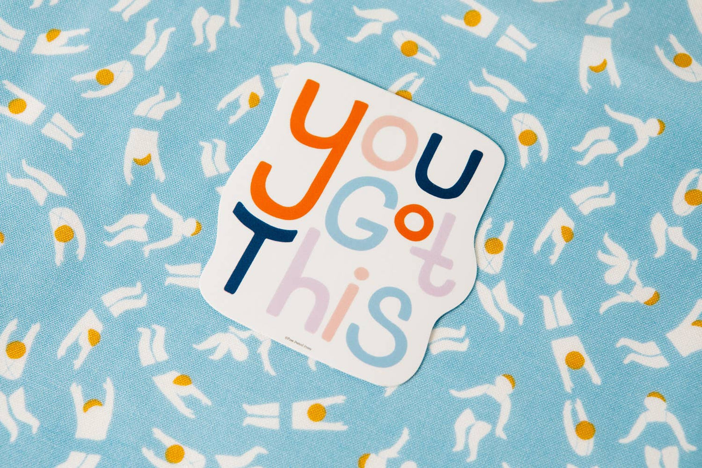 "You Got This vinyl decal sticker on blue patterned fabric, perfect for journaling, guided journaling, and journal supplies by Katie Daugherty"