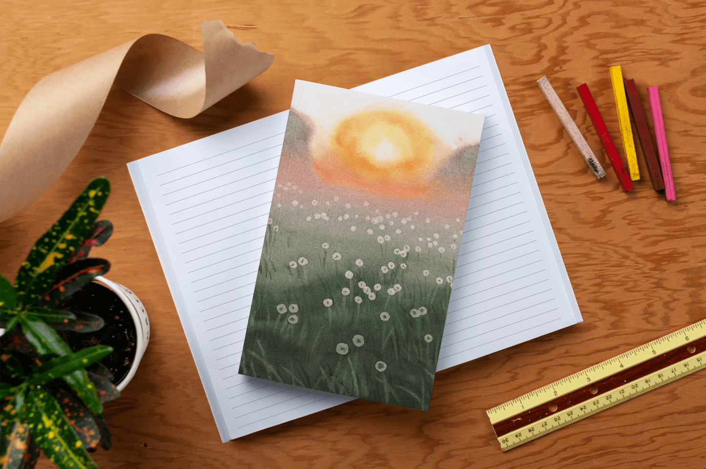 Dewy Morning Classic Layflat Journal Notebook with vibrant nature cover on desk, surrounded by colorful journaling supplies.