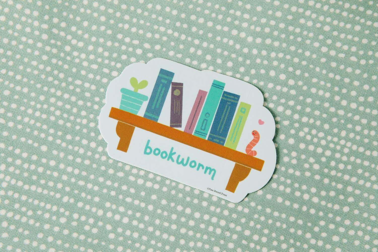 Bookworm vinyl decal sticker featuring books on a shelf with a cute worm, perfect for laptops, journals, water bottles, and more!