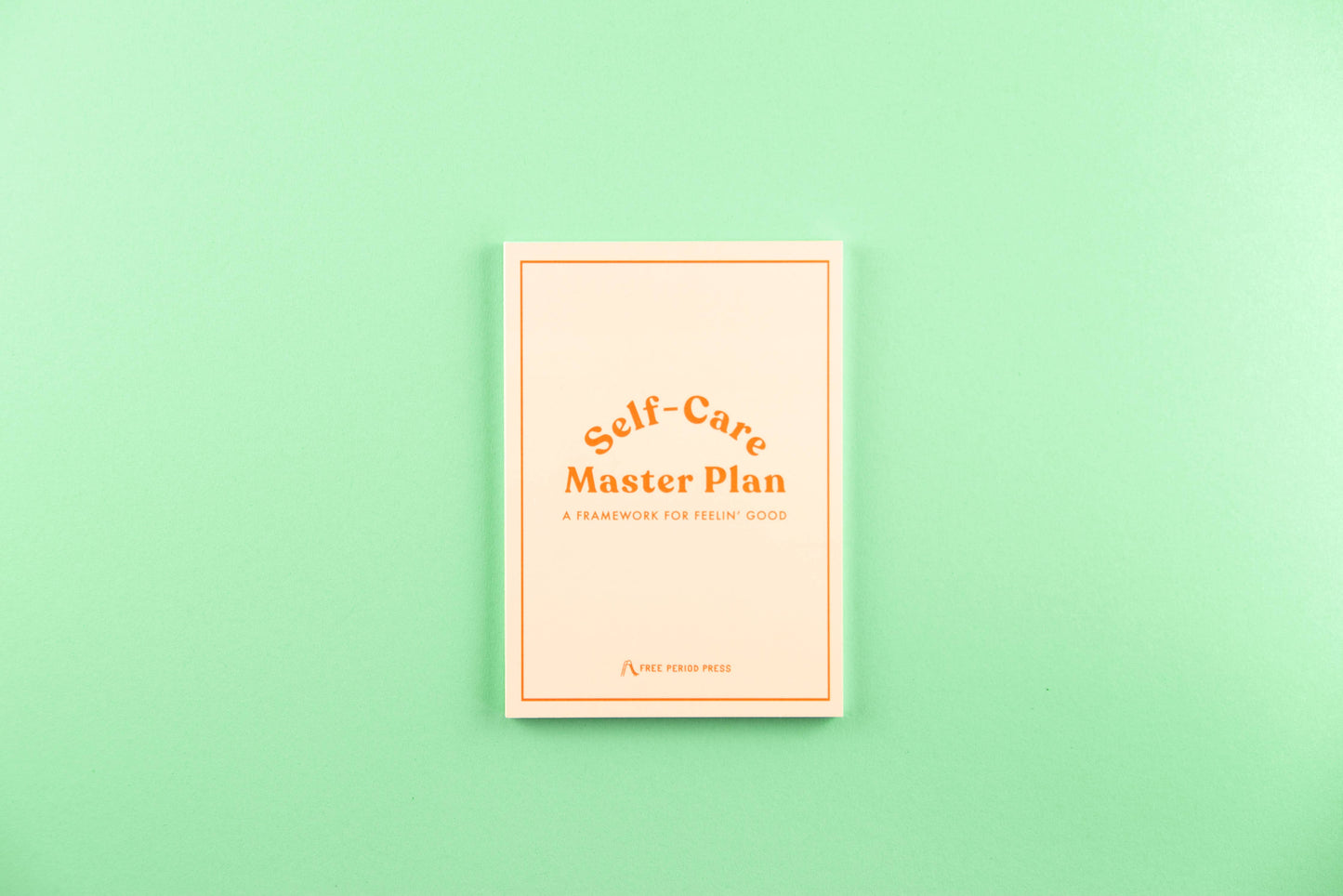 Self-Care Master Plan book on a mint green background for guided journaling and journal prompts.