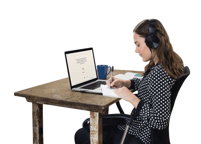 Woman using Journal Party Premium on laptop while writing in physical journal, highlighting lifetime access to guided journaling programs.