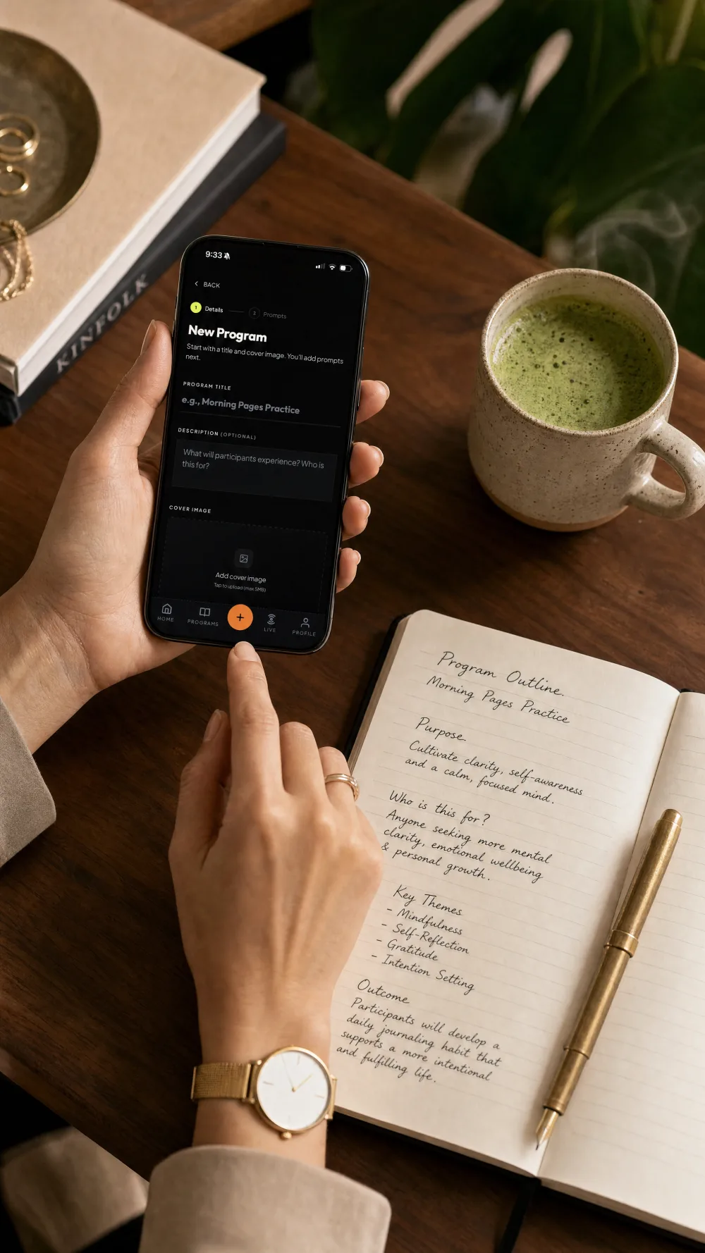A creator building a new Journal Party program on a phone beside a handwritten paper outline